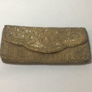 Sparkly gold sequined “Bechamel” brand clutch or cross body. Has metal strap.